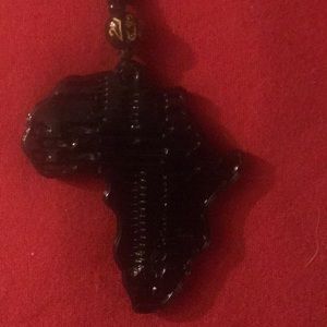 This is an all black ceramic Africa necklace